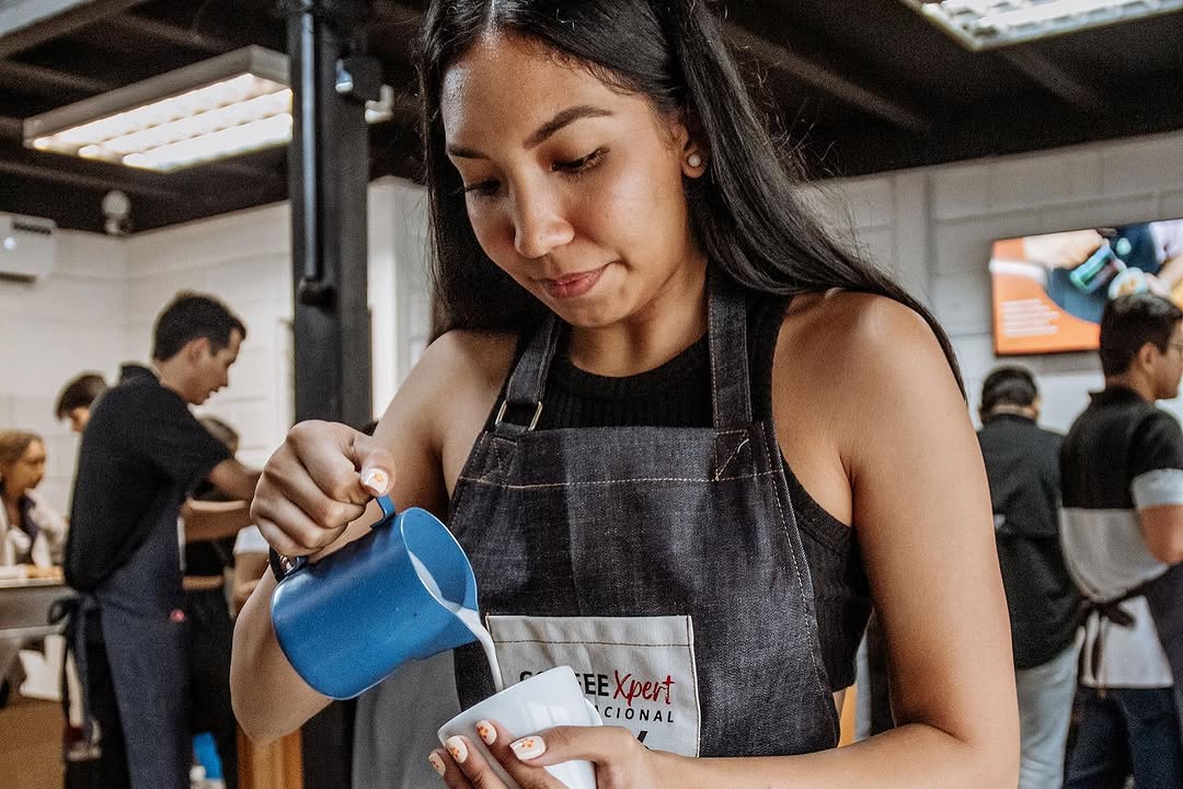 Barista pulling an espresso shot during hands-on training at the Miami coffee school