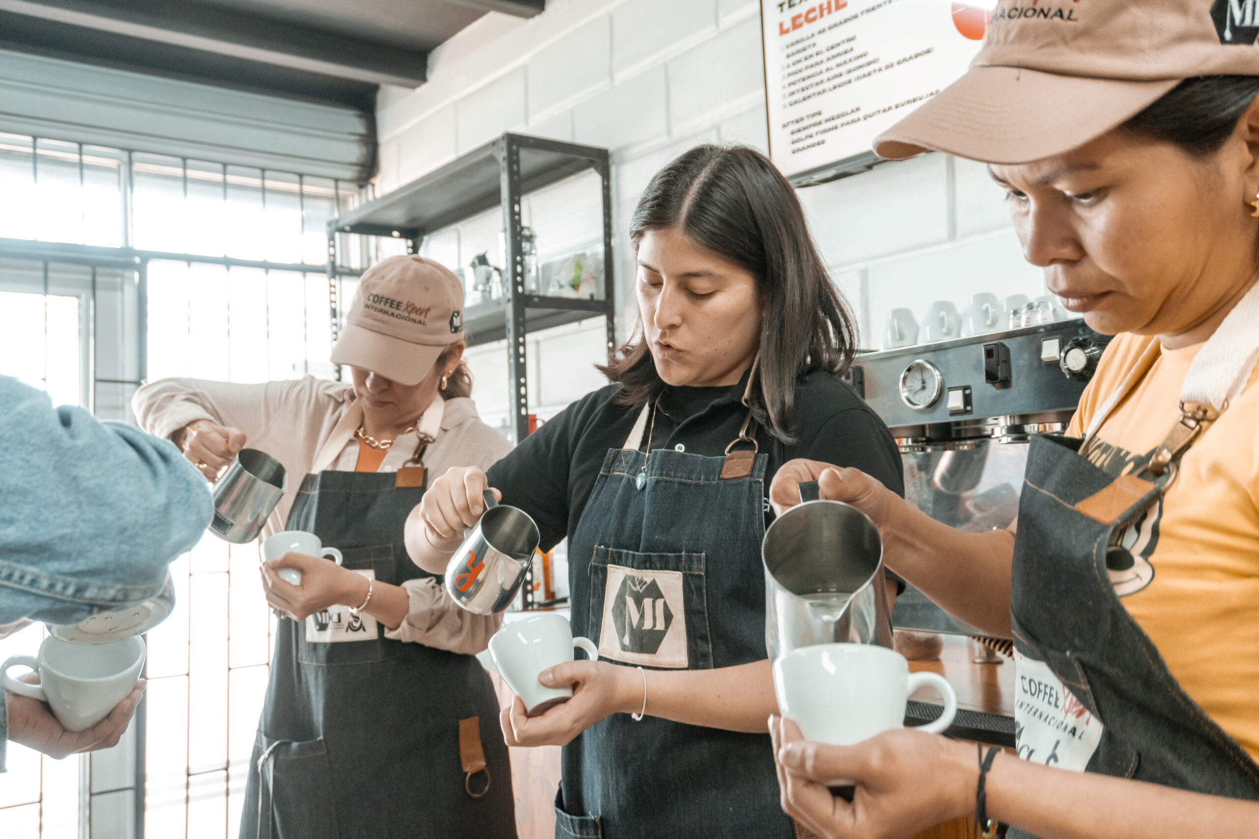 Students practicing milk steaming and latte art in the SCA Barista Skills Course